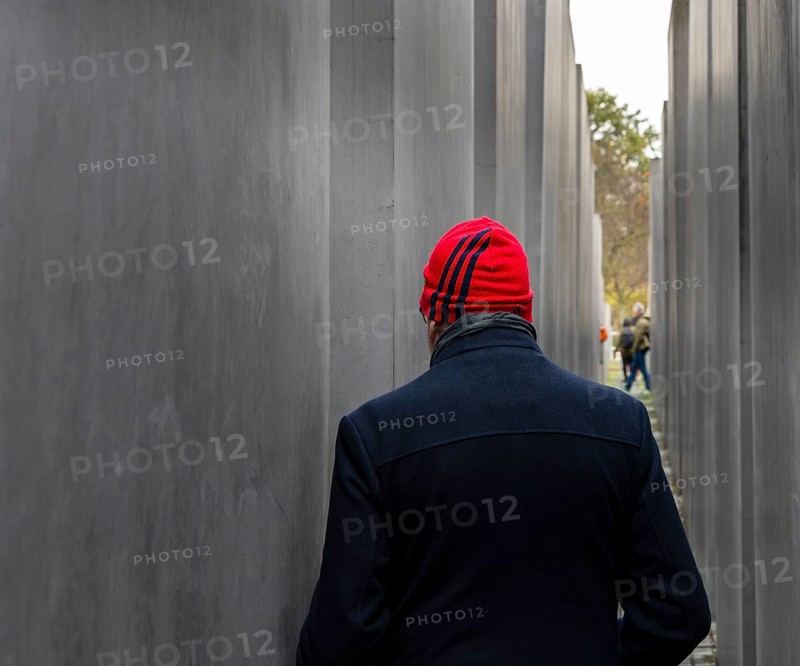 Tourist with red cap between the steles of the Holocaust Memorial