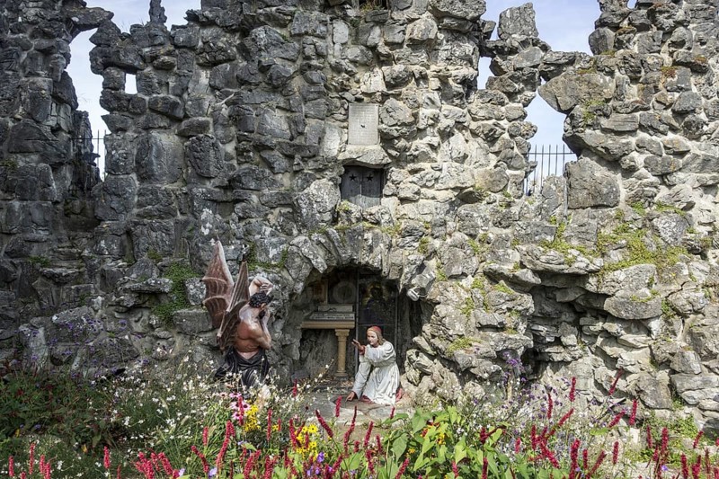 Sculpture of the devil and St Anthony of Padua at grotto in the village Crupet