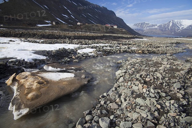 Melting snow and ice in river near Longyearbyen in spring