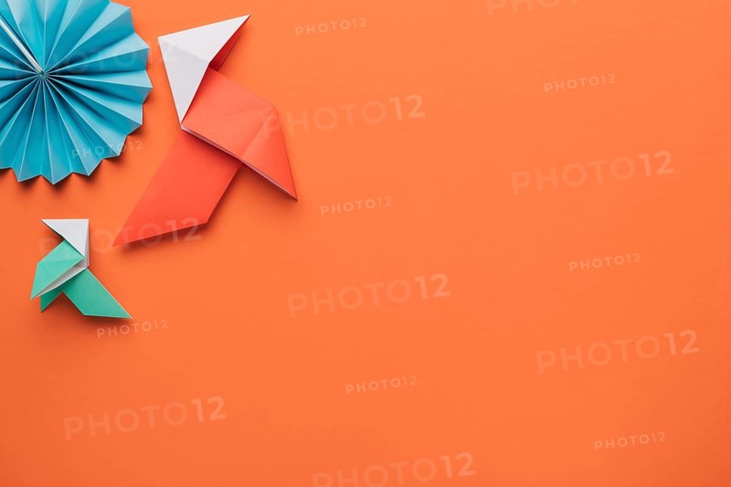 Origami paper craft art dark orange surface