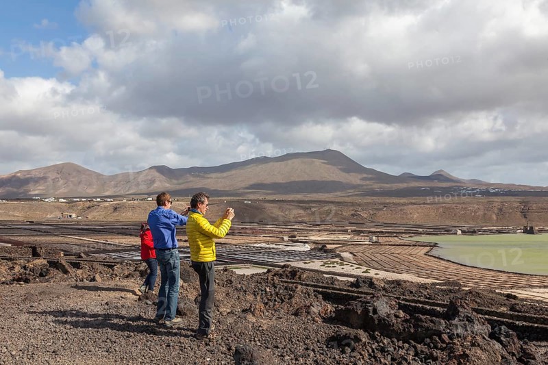 Tourists photographing the Janubio salt flats