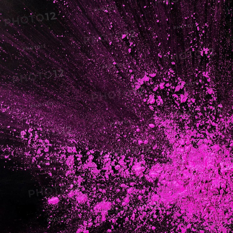 Pink dust particles splash against black background