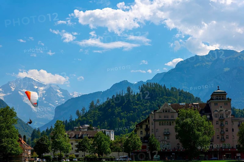 Paragliding in front Of Snow Capped Jungfraujoch Mountain in a Sunny Day in Interlaken