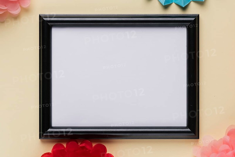 Elevated view white empty frame beige backdrop