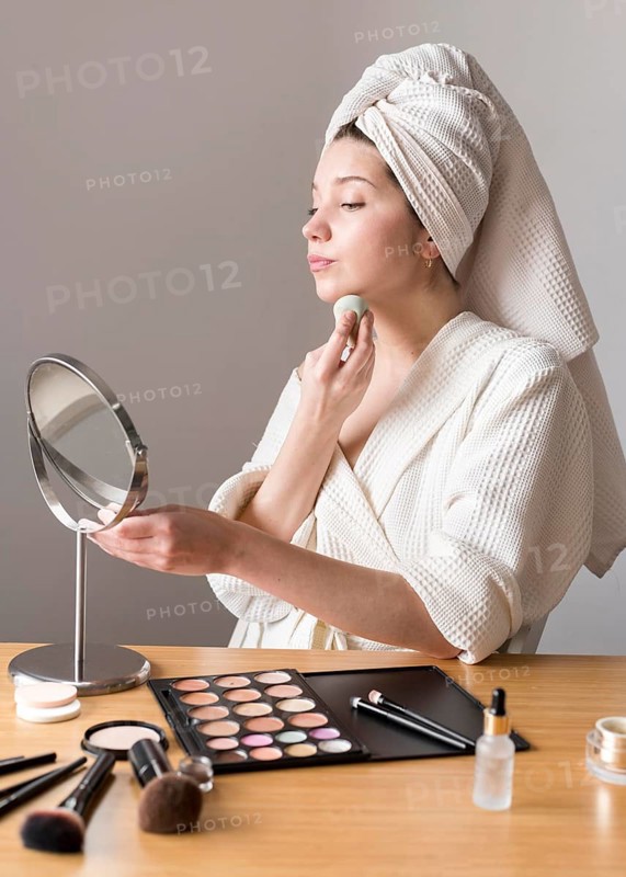 Portrait woman make up with sponge mirror