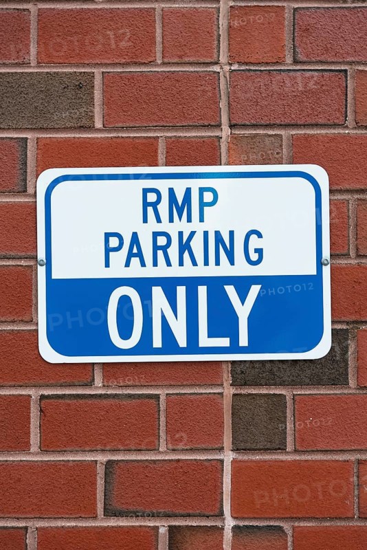 Parking sign brick wall closeup