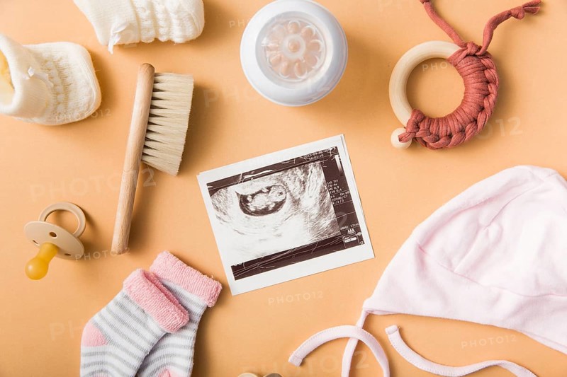 Sock brush pacifier cap milk bottle toy orange background