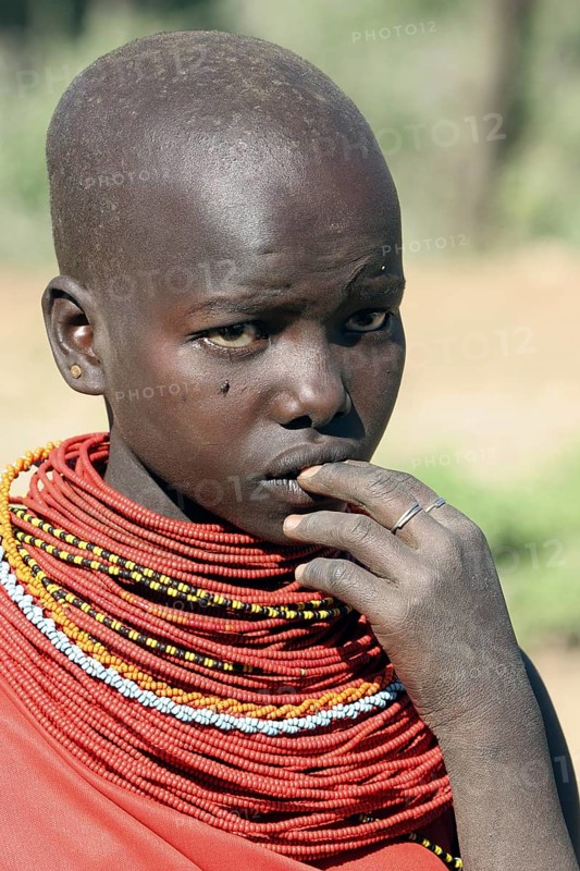 Portrait of young Turkana woman in traditional red clothing in northwest Kenya