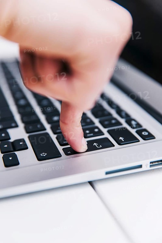 Person pressing enter key