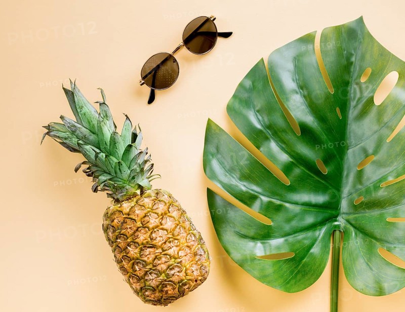 Top view pineapple with sunglasses leaf