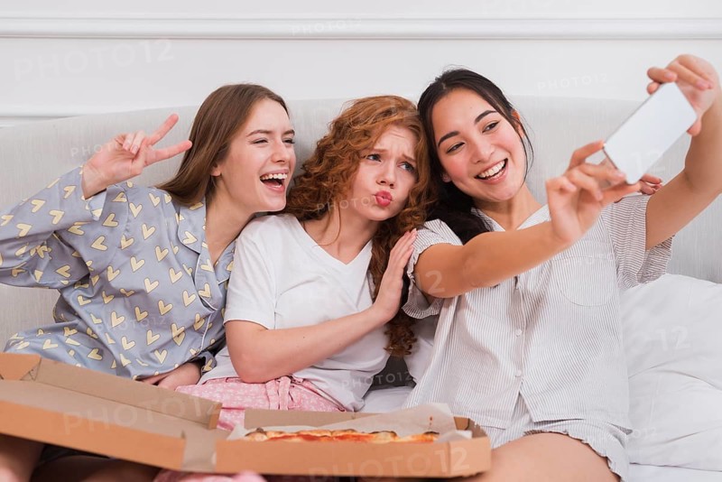 Playful girlfriends taking selfie