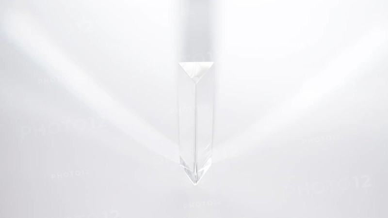 Prism dispersing sunlight white background