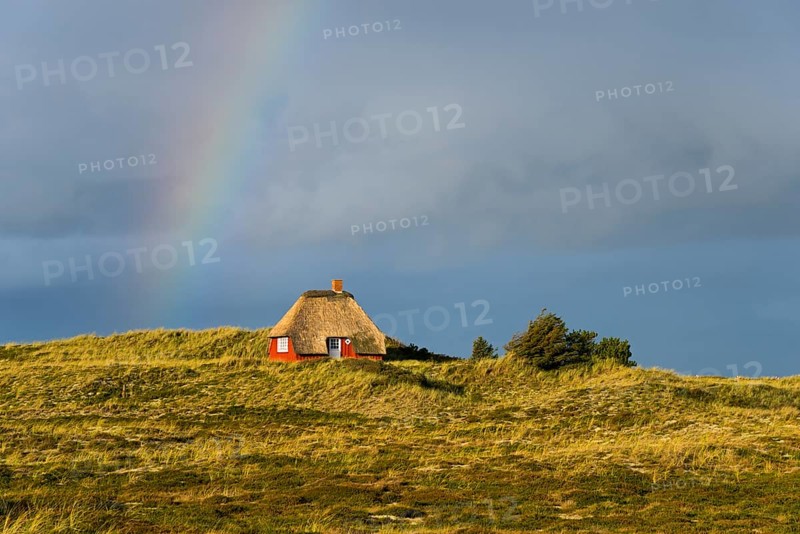 Rainbow and thatched house