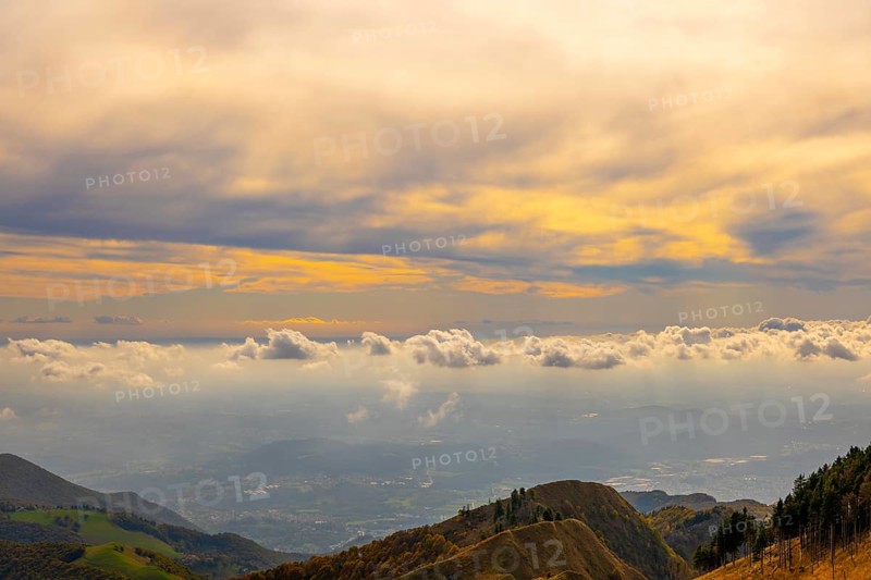 Aerial View over Beautiful Mountainscape with Floating Clouds with Sunlight From Monte Generoso
