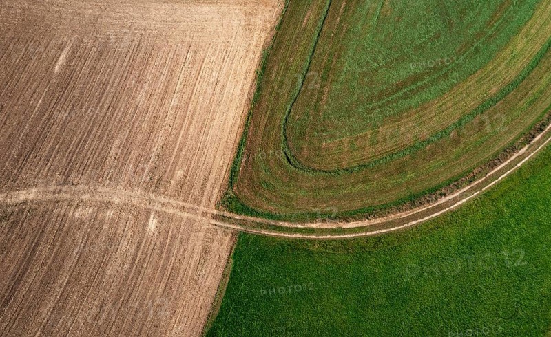 Drone view of green and ploughed fields with field path near Pabneukirchen