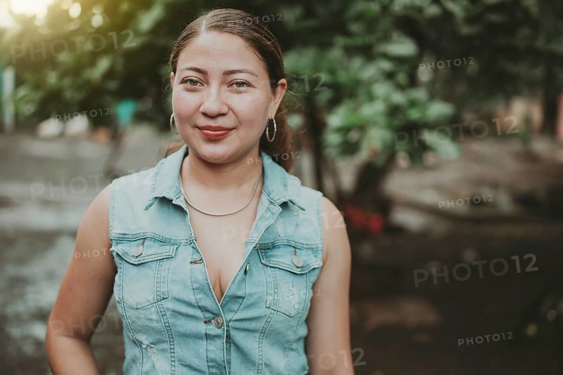 Portrait of Latin American girl face looking and smiling at the camera. Portrait of young Nicaraguan woman smiling at camera. Portrait of attractive latin girl smiling outdoors