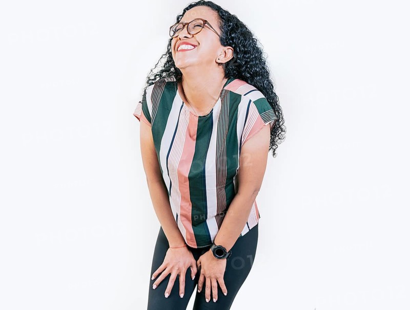 Young woman in glasses laughing out loud isolated. Funny young afro woman laughing on isolated background