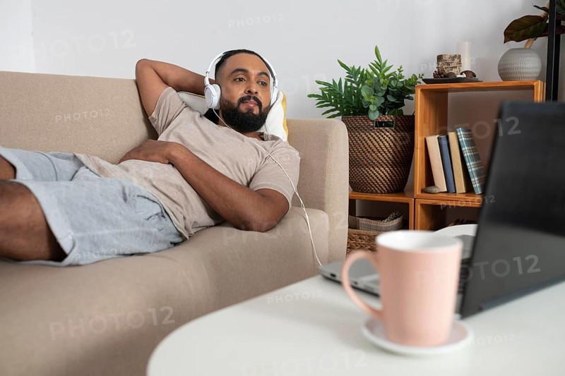 Medium shot man laying couch