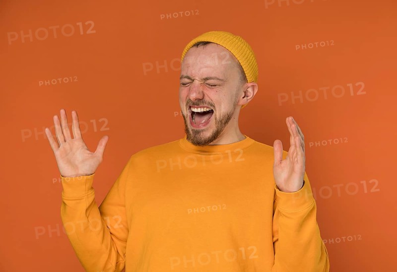 Happy young man laughing indoors 6