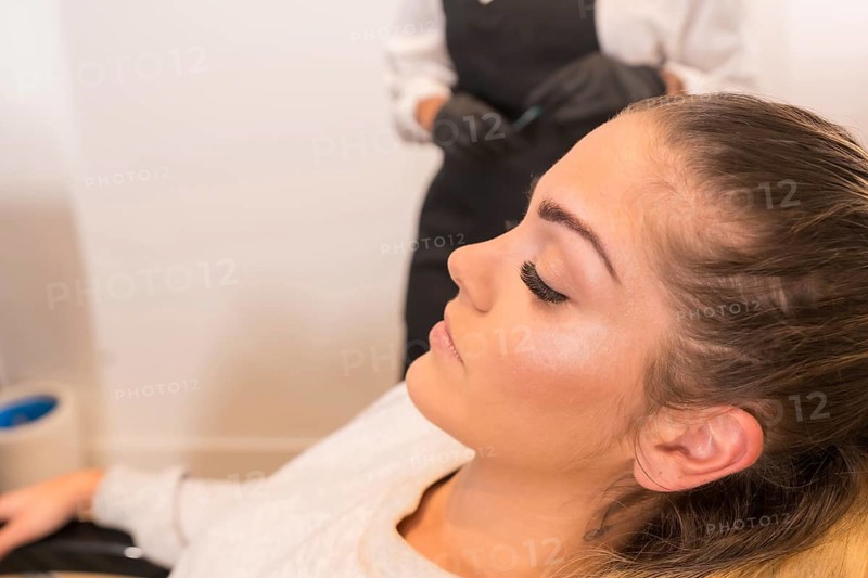 Close-up profile of a beauty woman sitting on a chair of a beauty salon