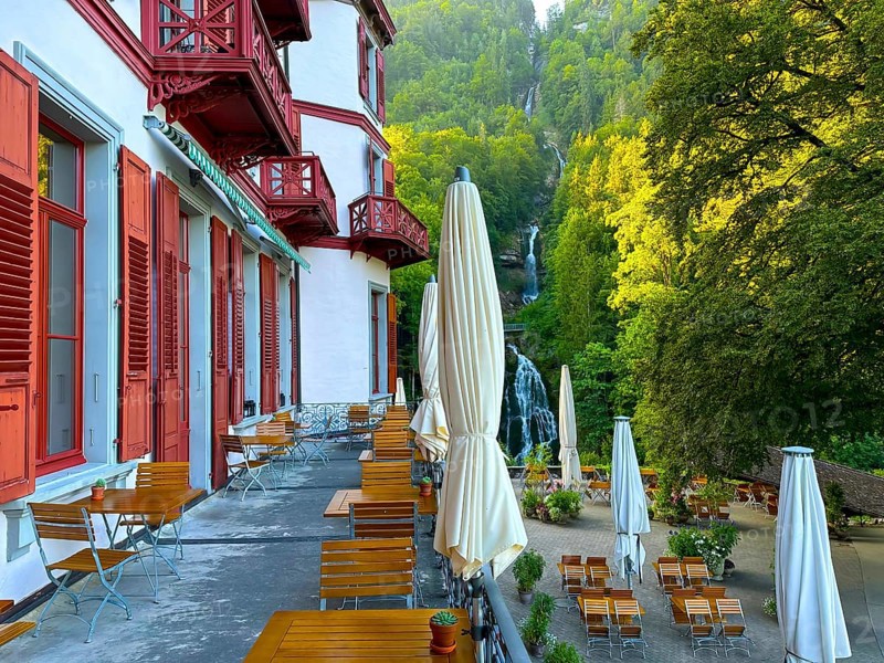 Grandhotel Giessbach with Terrace View over Giessbach waterfall in a Sunny Summer Day in Brienz