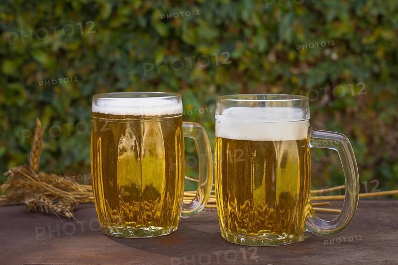 Front view two pints table with foaming beer