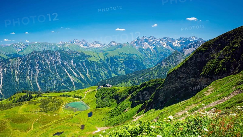 Panorama from the Fellhorn over the Schlappoldsee and Fellhornbahn mountain station to the central main ridge of the Allgaeu Alps