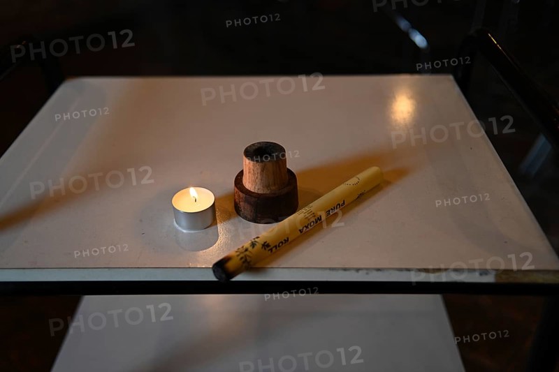 Burning mugwort or moxa herb and candle to facilitate healing blood flow in naturopathy clinic