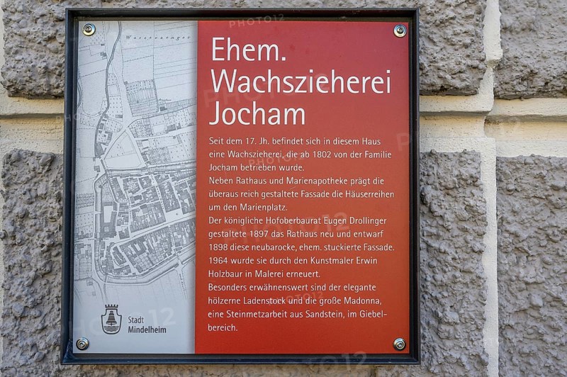 Information board about the former Jocham house with a statue of the Virgin Mary