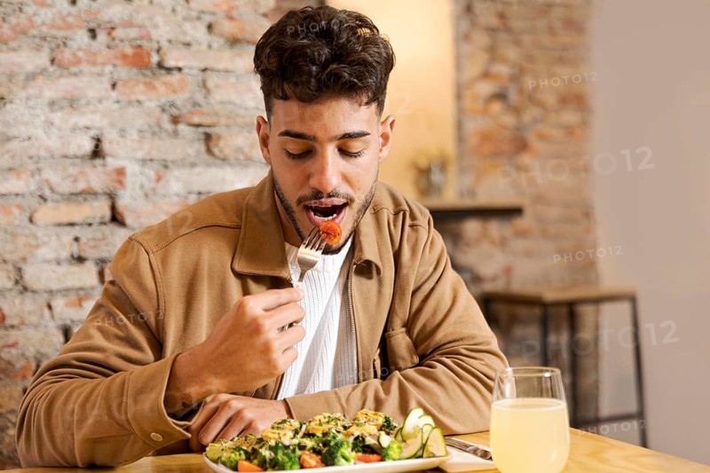 Medium shot man eating indoors
