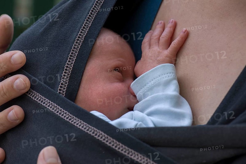 Infant in sling with mother