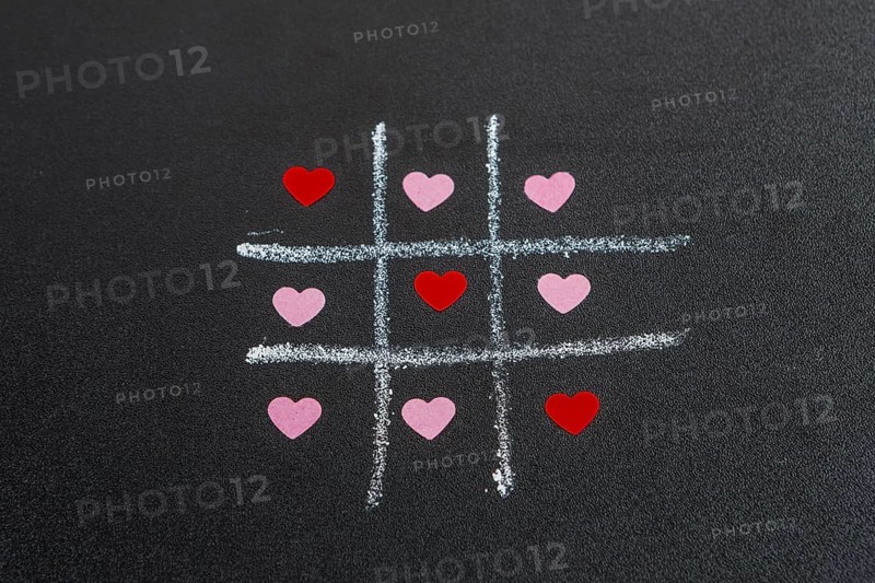 Tic tac toe game with ornament hearts