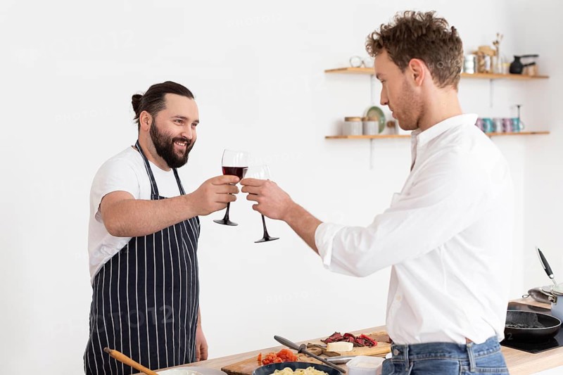 Medium shot men clinking glasses