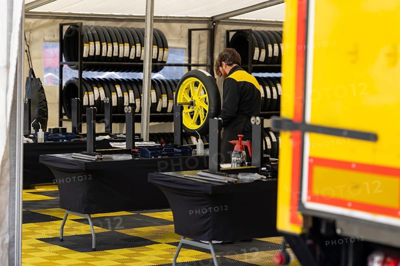 A Man Repairing a Tire of sportive motorbikes