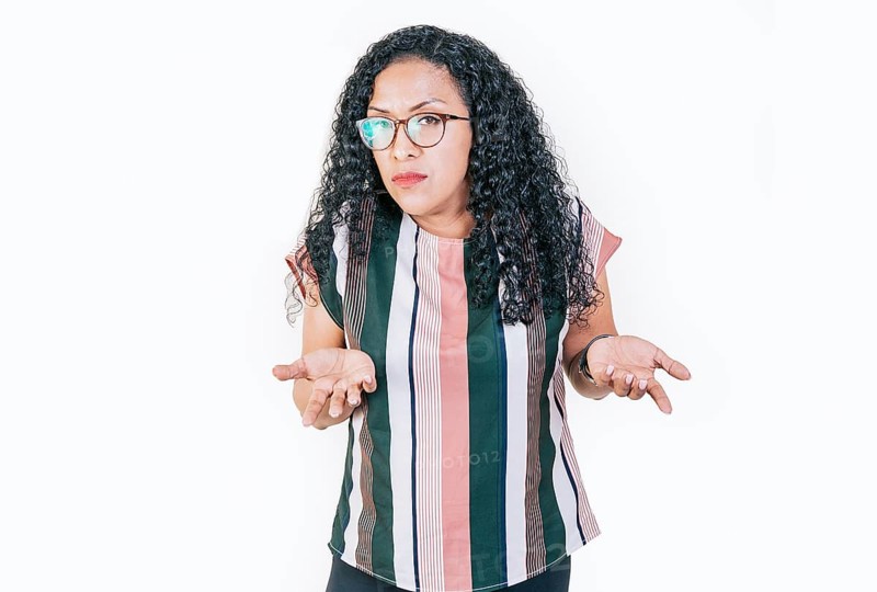 Puzzled afro woman gesturing with hand isolated. Girl in glasses with puzzled face frowning. Puzzled people making hand gestures