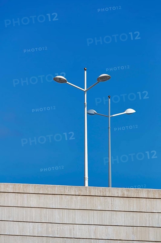 White street lamps against a blue sky