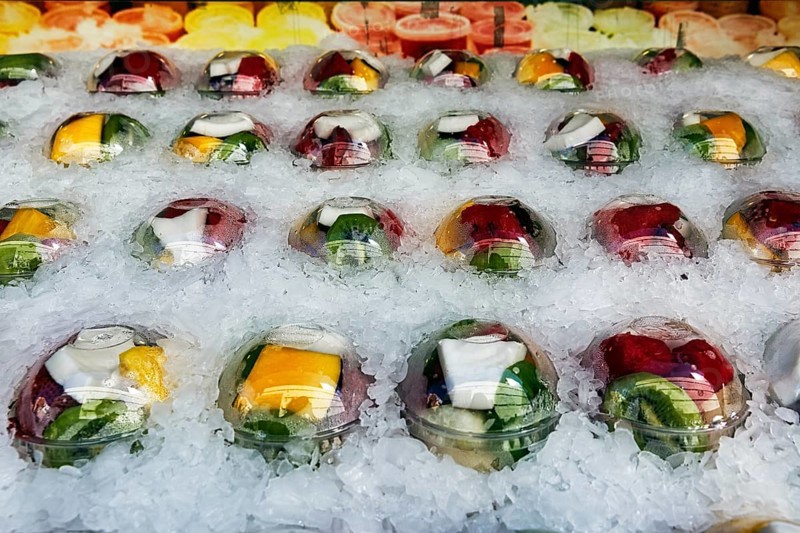 Freshly cut and ready-to-cook fruit in plastic cups