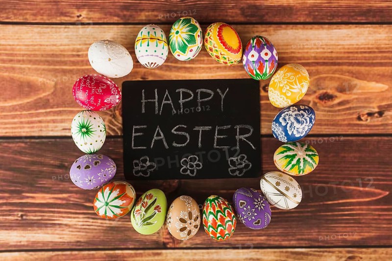 Easter eggs around paper with writing