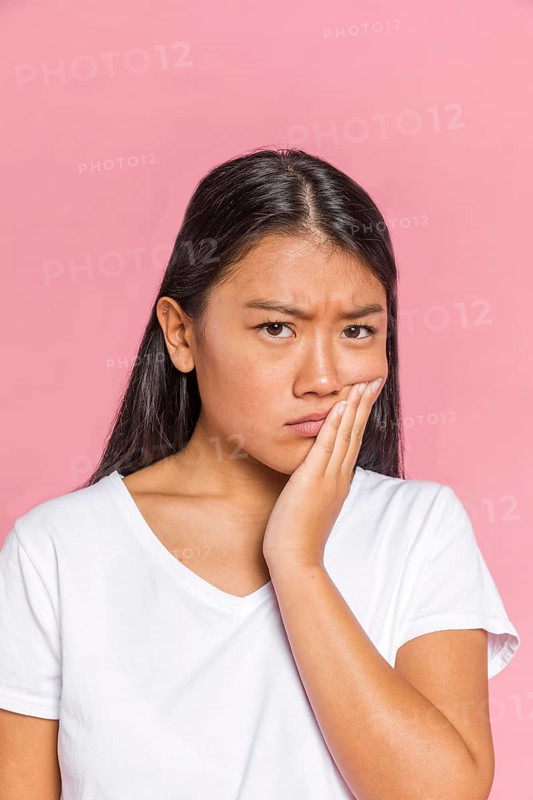 Black hair woman frowning looking camera