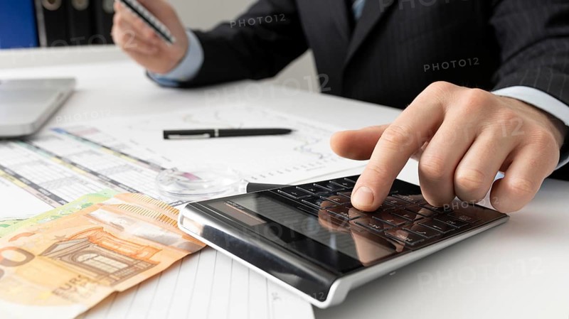 Business man calculating finance numbers close up