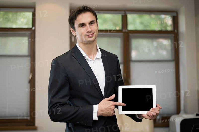 Medium shot businessman holding tablet
