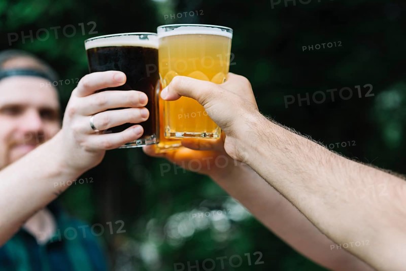 Close up friend s hand cheering glass alcoholic drinks