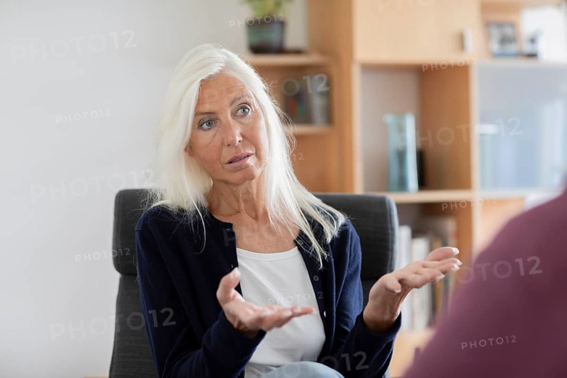 Therapist talking to a patient in a practice