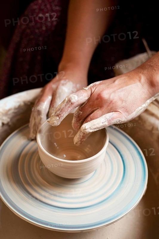 Person modeling clay potter s wheel