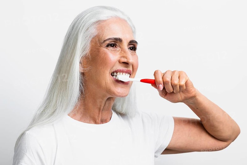 Beautiful woman using toothbrush