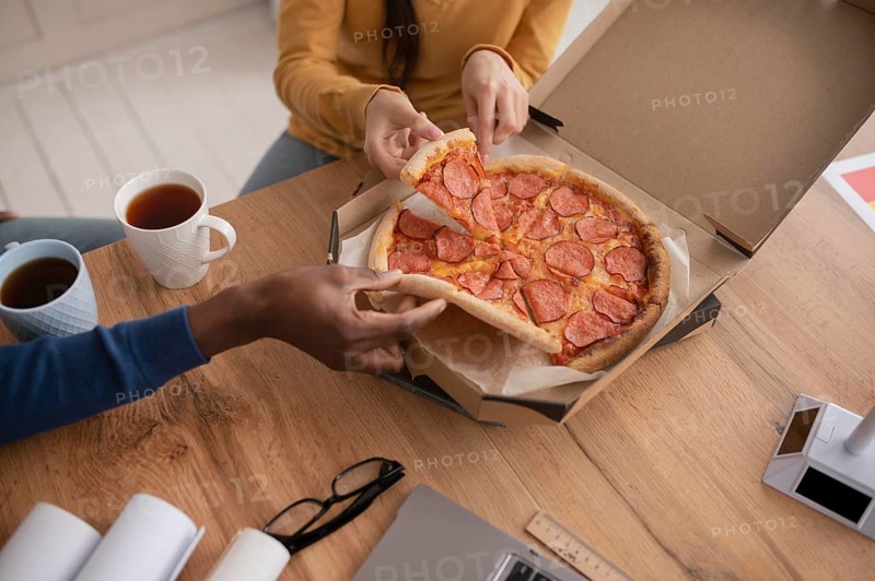 Colleagues work having lunch close up