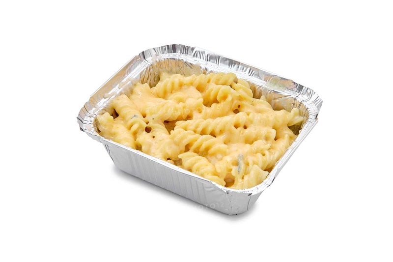 Classic mac and cheese in foil container isolated on white background