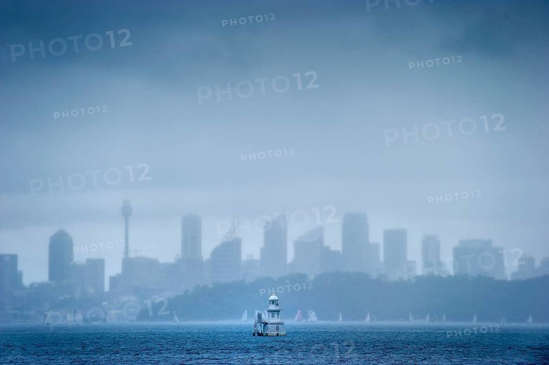 Skyline with lighthouse from Watson bay in the rain