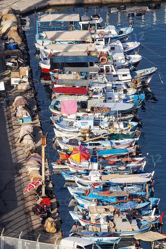 Numerous colourful fishing boats moored at the jetty