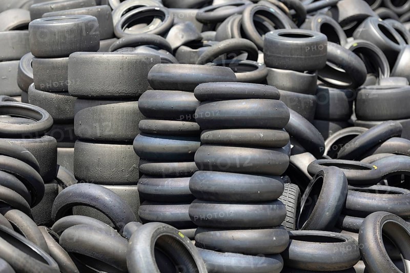 A pile of old tires sitting next to each other